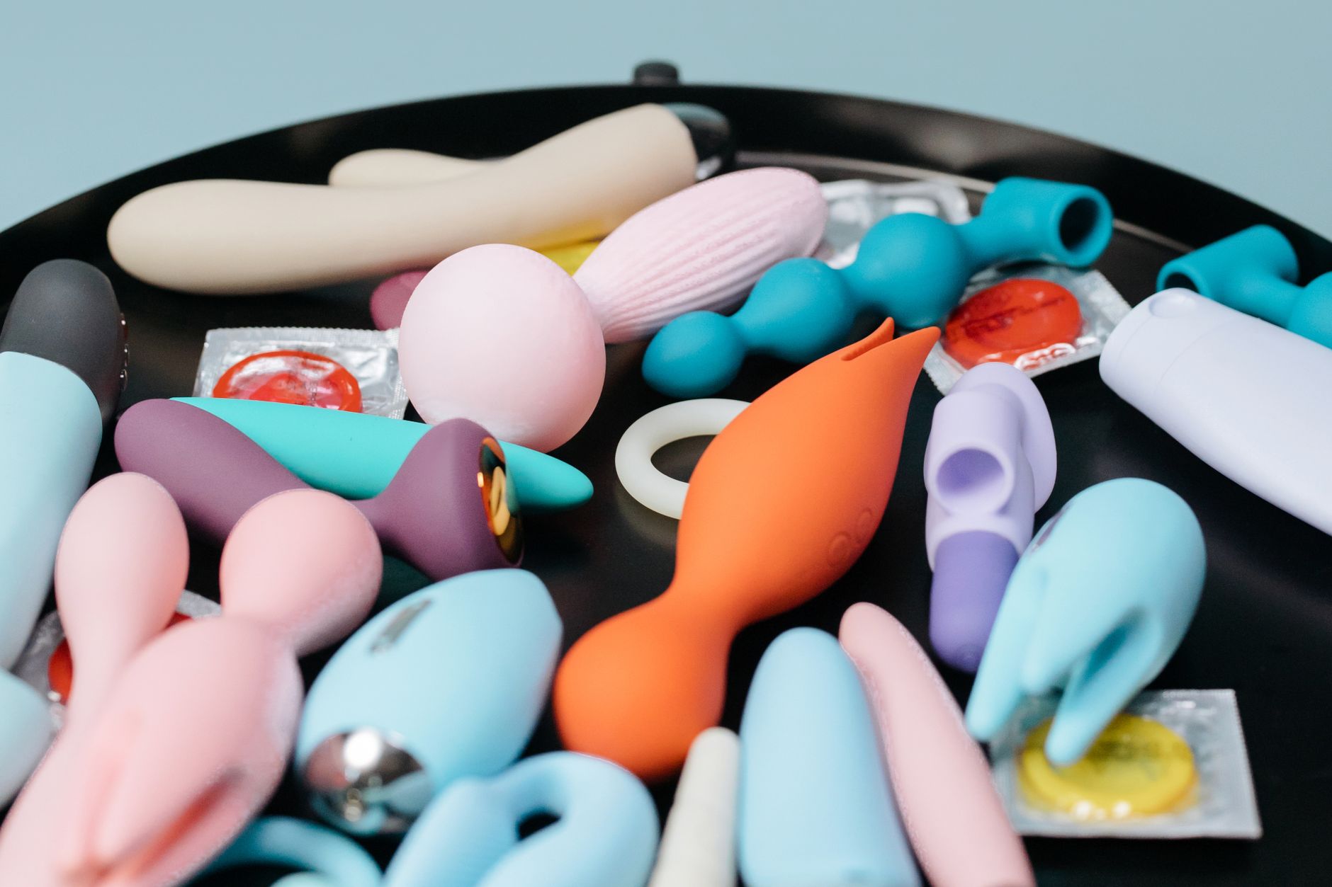 Person holding colorful vibrators with confidence and intention