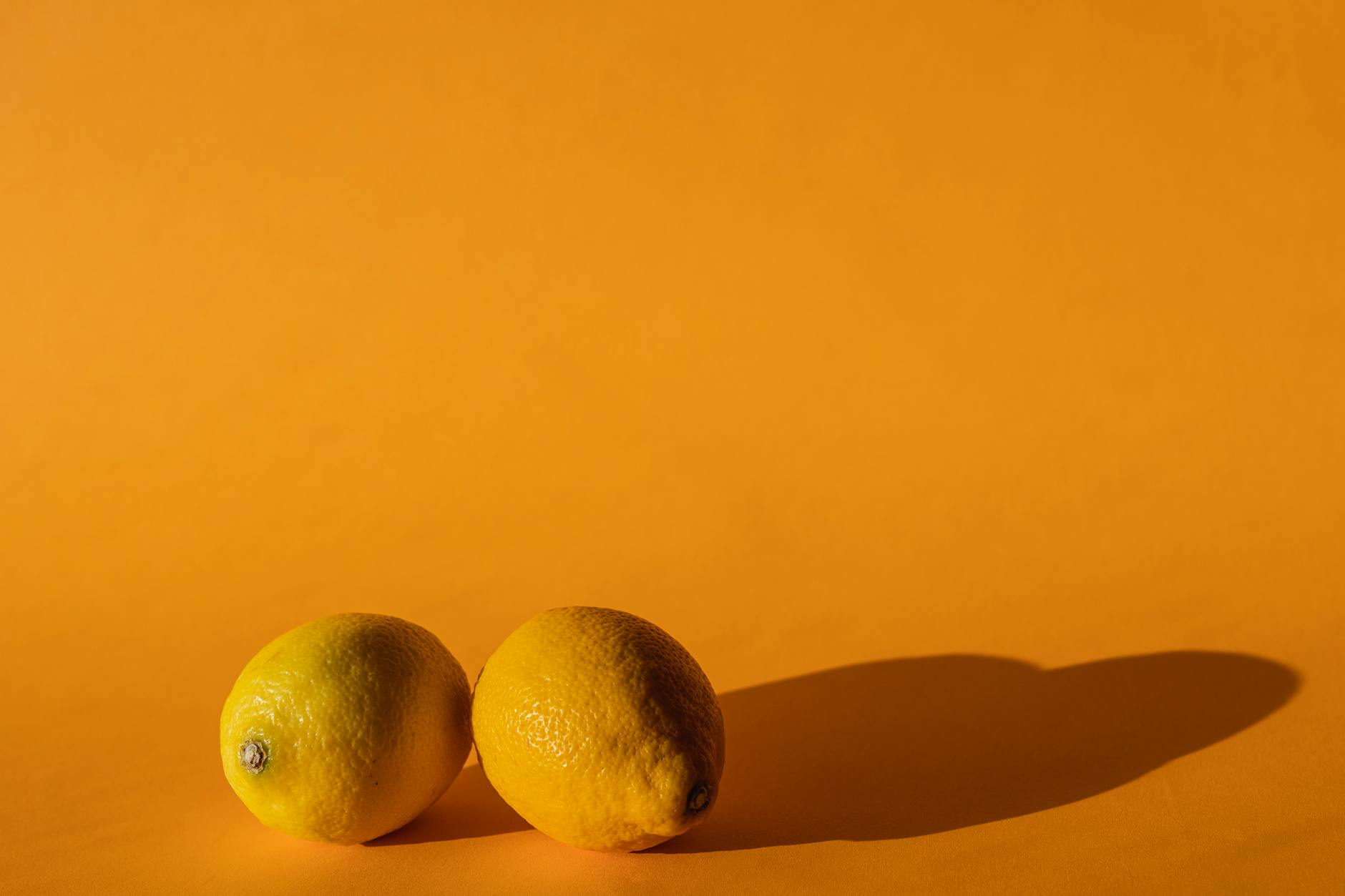 Bright yellow lemons arranged on a vivid background, symbolizing fresh approaches to pleasure and body awareness